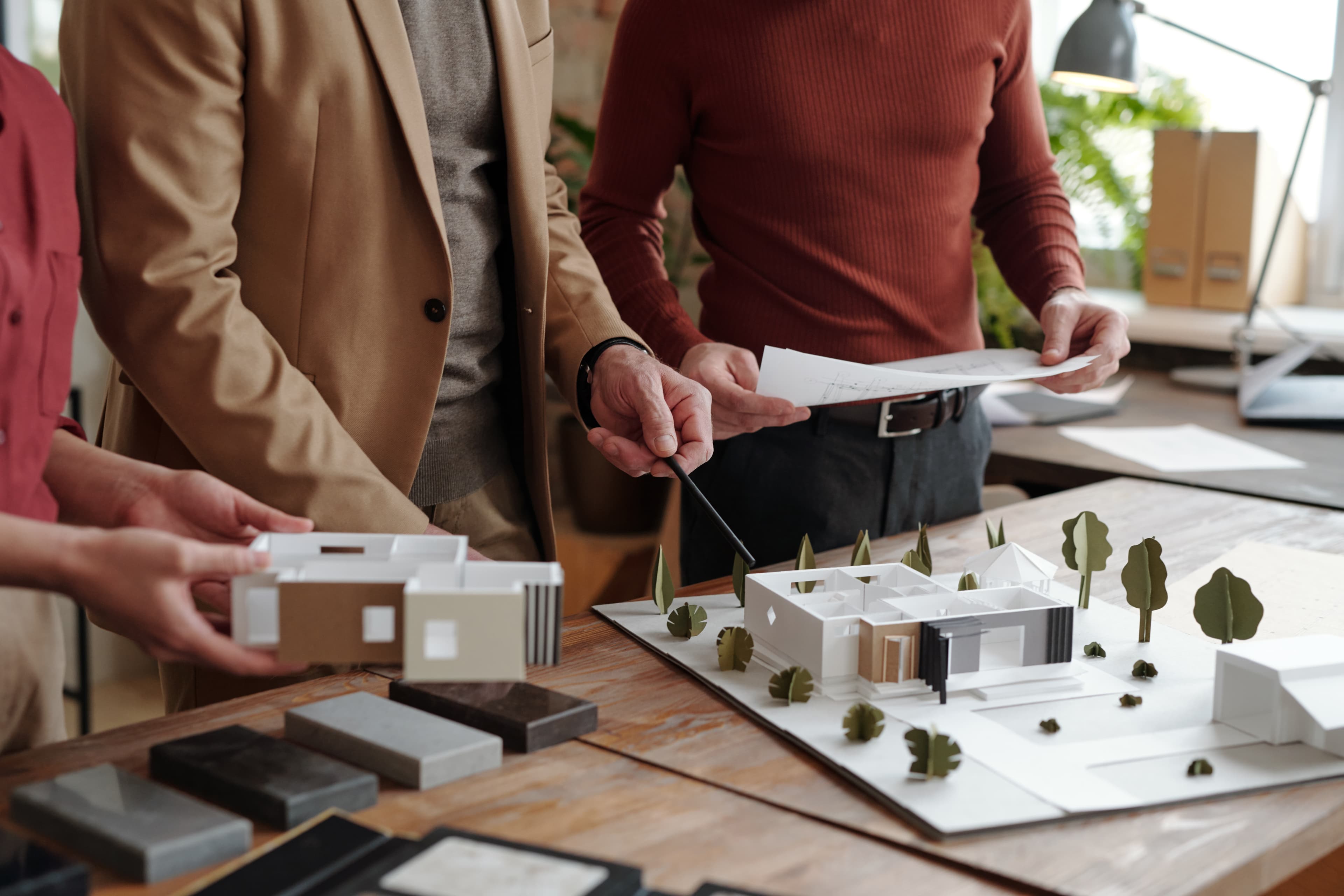Clients exploring an architectural real estate model